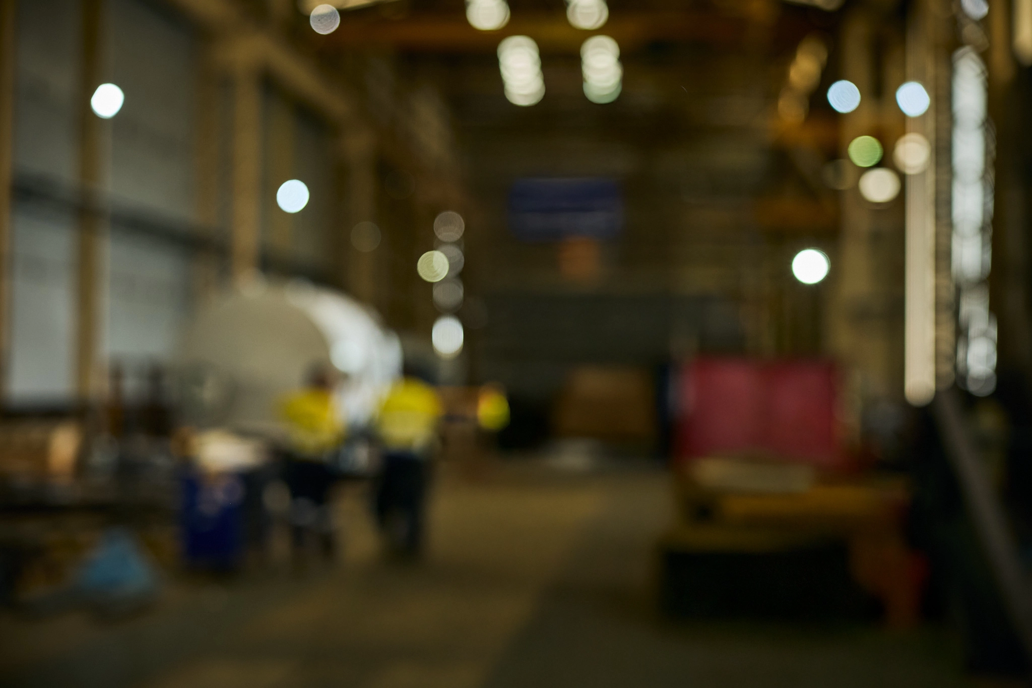 Industrial warehouse interior with equipment and workers at Altrad Australia.